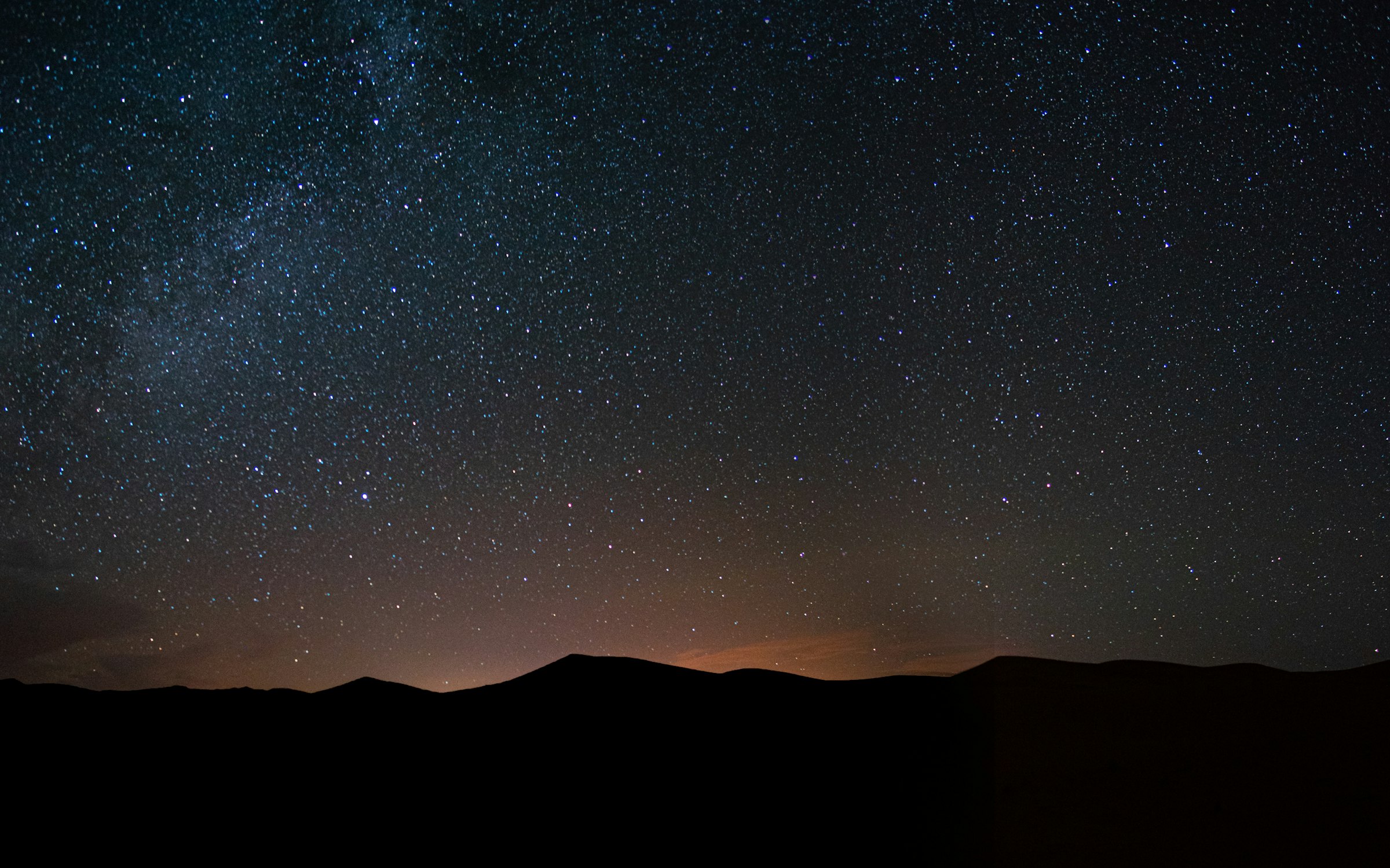 Stars over a black desert ridge